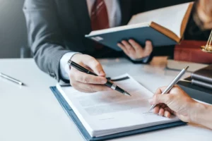 A snapshot of a lawyer consulting a client, guiding them through filing a claim with insurance.