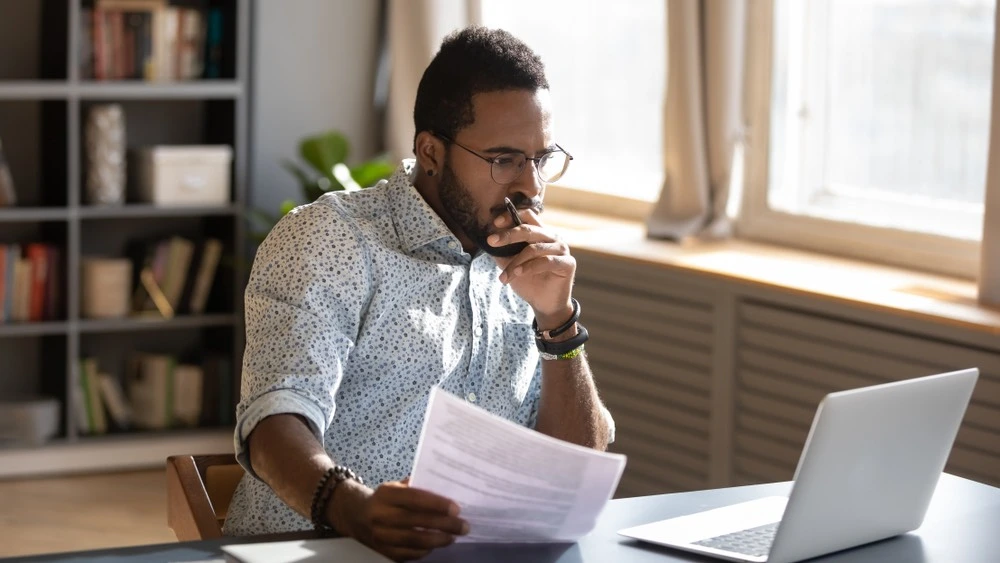 A person reviewing insurance documents, highlighting the importance of understanding your insurance coverage options after a car accident.