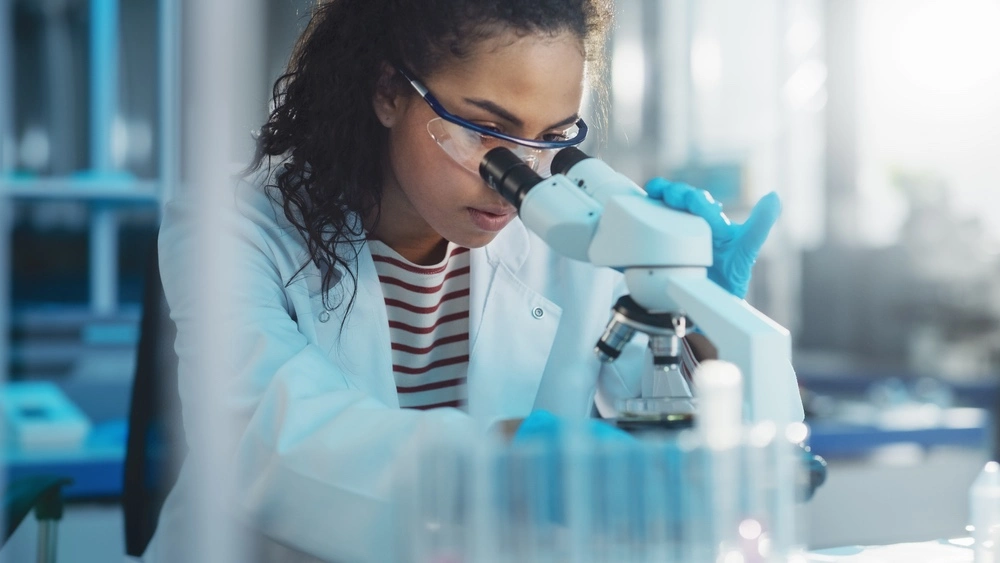 A snapshot of a medical professional using a microscope to examine various infections that can result from dog bites.