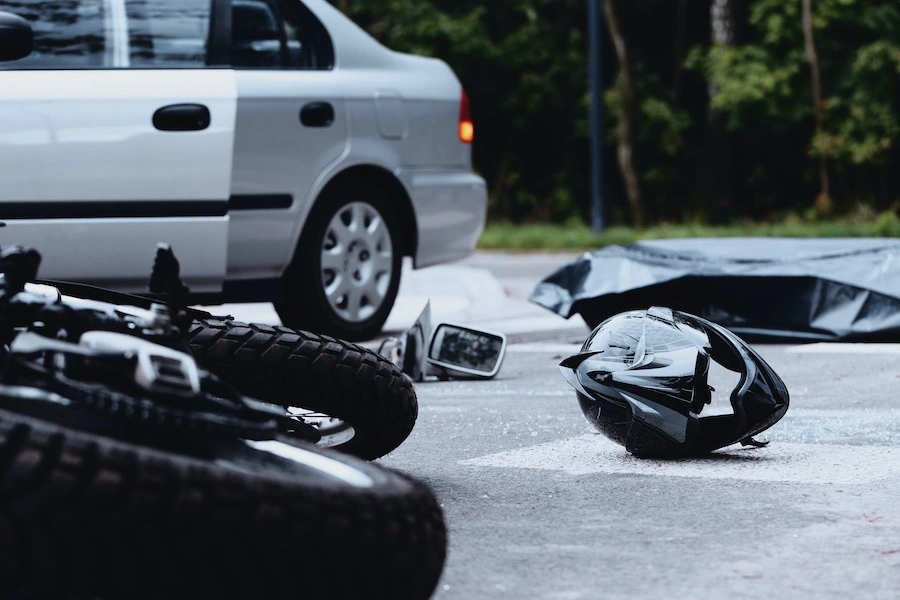 A motorcycle accident scene with evidence being gathered by law enforcement.