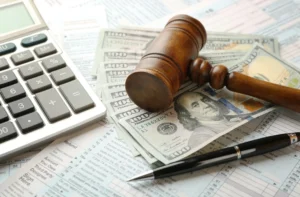 Snapshot of a gavel and cash, symbolizing the goal of maximizing your car accident settlement.
