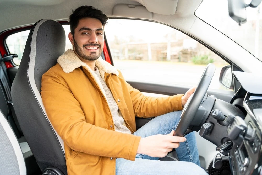 Snapshot of a driver instructor seated behind the wheel, emphasizing the importance of teen driver safety through education and training.