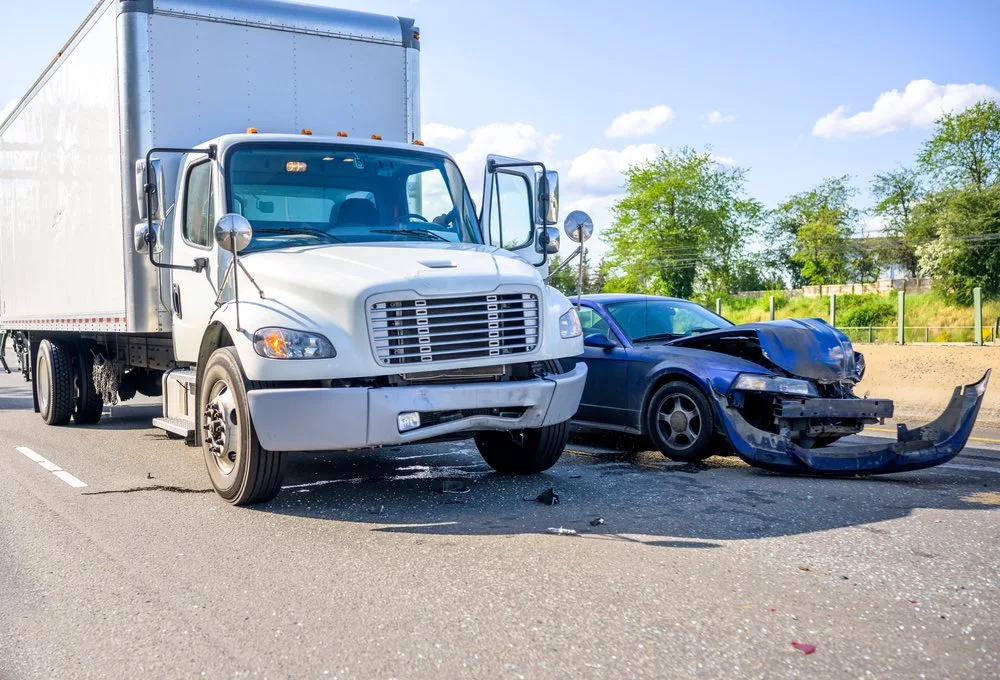 Snapshot of a collision between a commercial truck and a car, symbolizing the dangers and impact of commercial vehicle accidents in St. Louis.