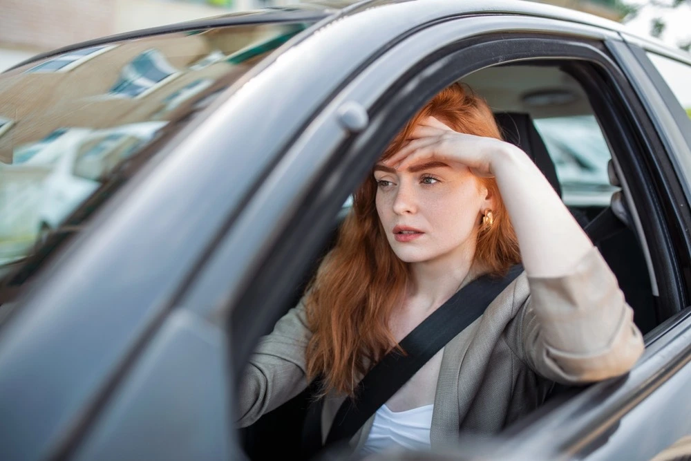 Snapshot of a person sitting in a car, underscoring the issues surrounding rideshare and app-based transportation in passenger accident cases.
