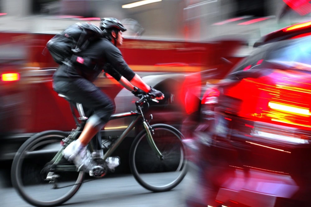 Snapshot of a cyclist maneuvering through traffic, illustrating common accident locations and risks faced by riders in Benton Park.
