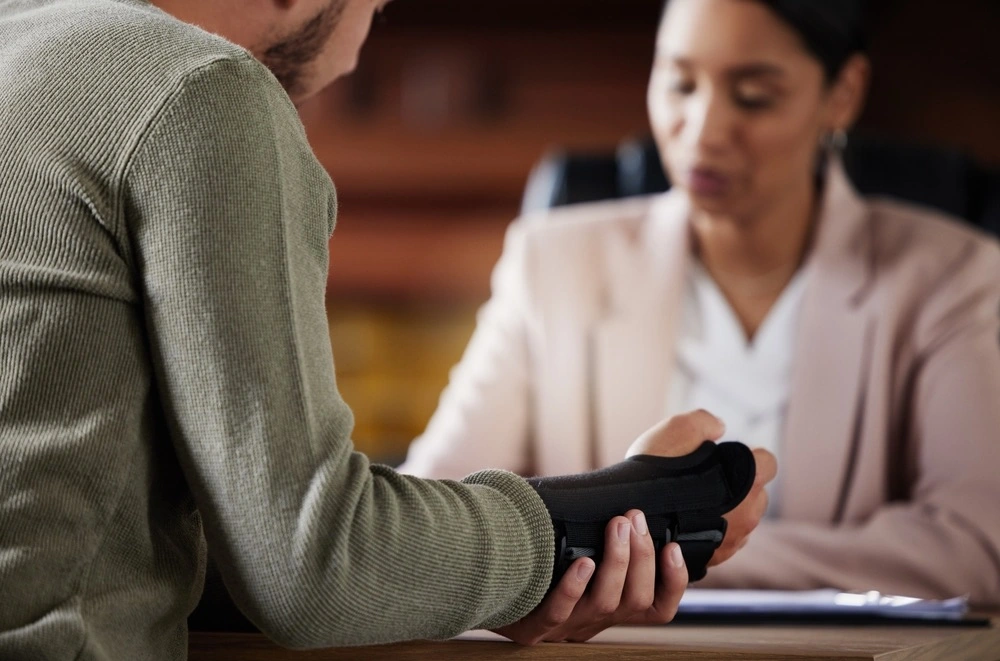 Snapshot of an injured person consulting with a personal injury lawyer, symbolizing the types of personal injury cases handled in University City by The Dixon Injury Firm.