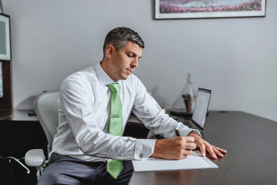 Chris Dixon reviewing case materials in an office, highlighting The Dixon Case Strength Method and the firm’s strategic approach to medical malpractice claims.