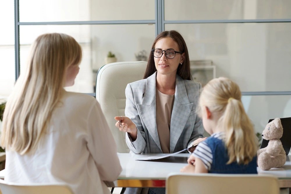 Parent with a child consulting a St. Louis dog bite lawyer in an office, illustrating special considerations for protecting child victims in pediatric dog attack cases.